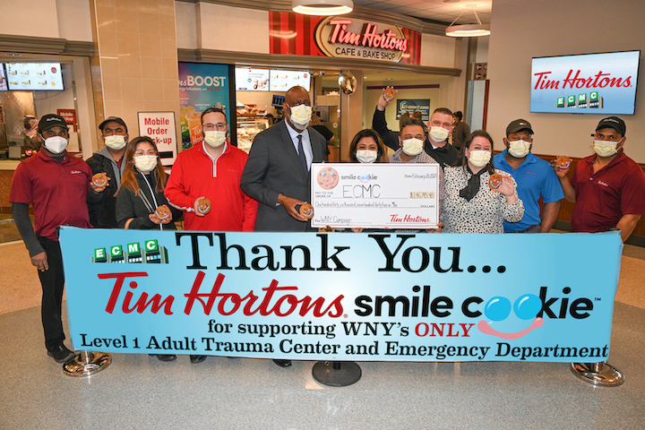 On Tuesday, Tim Hortons franchise owners, managers and representatives presented to ECMC Corp. COO Andrew L. Davis (fifth from left) a check in the amount of $146,745. The funds were raised during the Smile Cookie campaign to benefit ECMC frontline care services. (ECMC photo)