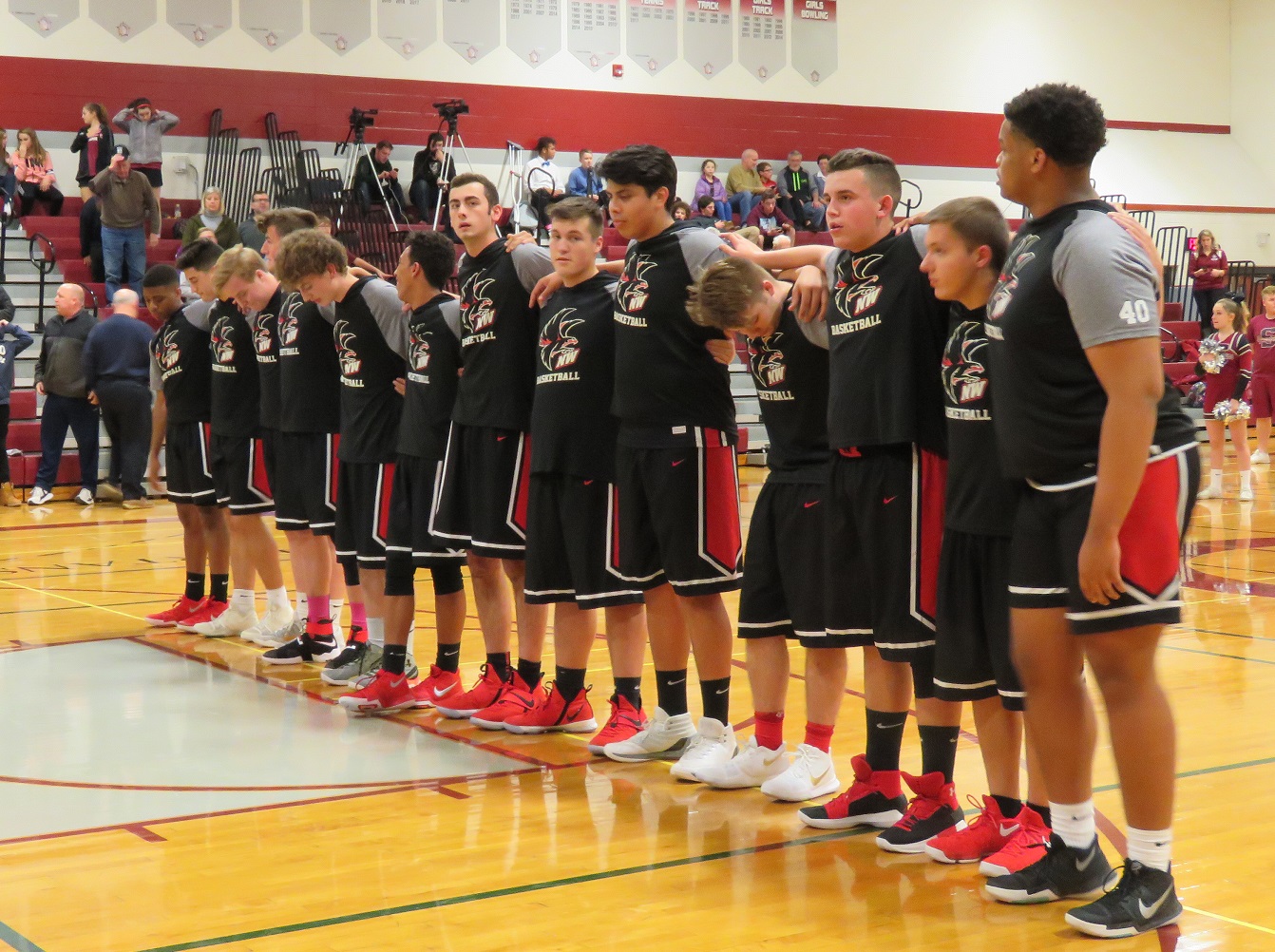 The Niagara-Wheatfield boys basketball team stands for the pledge before Tuesday night's contest versus Starpoint High School. (Photo by David Yarger)