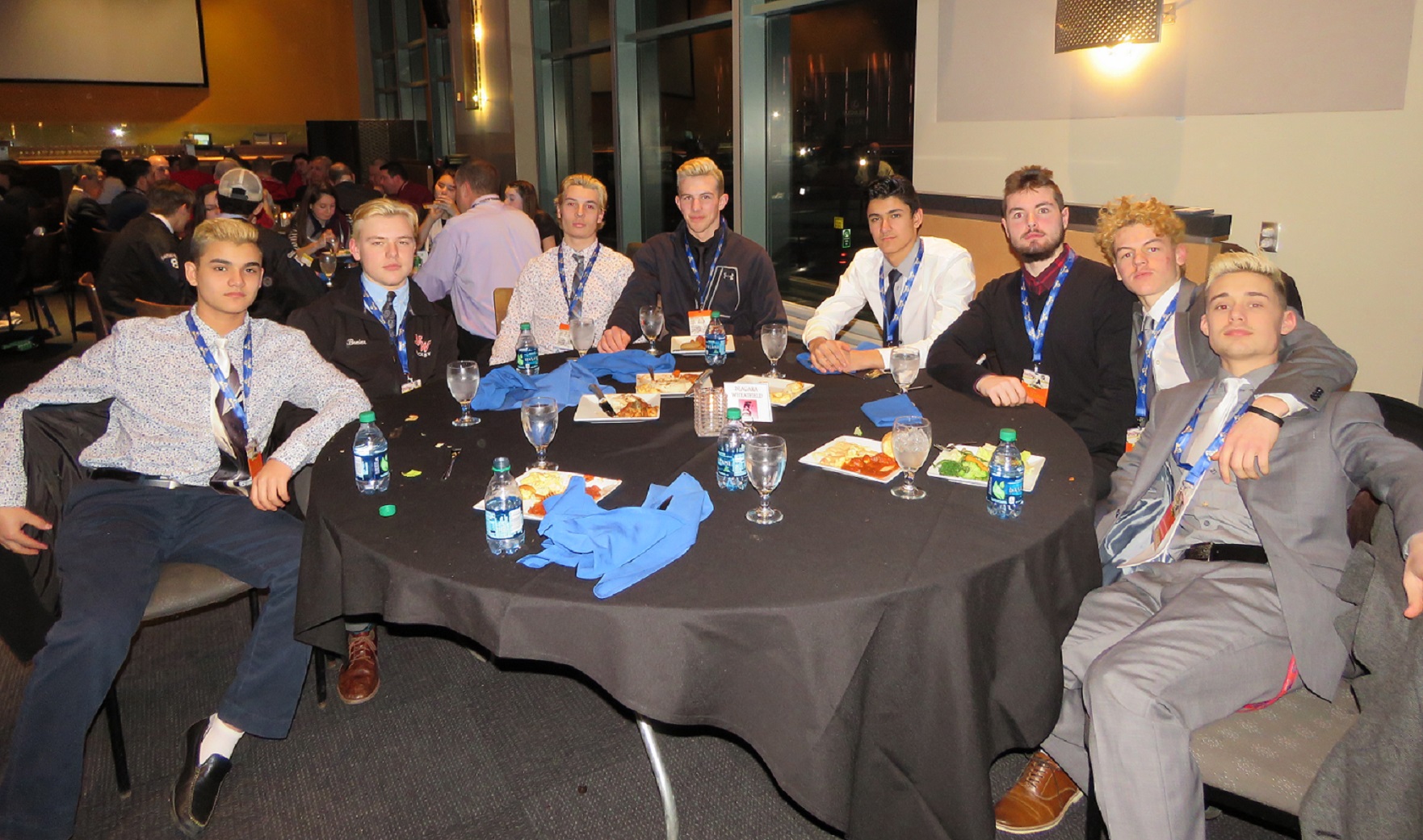 Members of the Niagara-Wheatfield Falcons hockey team take in the state tournament dinner Friday night at the Lexus Club in the KeyBank Center. From left: Dylan Woods, Nick Breier, Nick Peters, Zack Belter, Chace Woods, Chris Tobey, Michael Lotempio and Dom Pulli. (Photo by David Yarger)