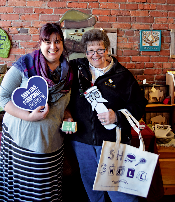 Winter Walk Committee Chair Heather Kalisiak (left) and Treasurer Suzanne Todaro, both owners of Webster Street businesses, pose for a photo holding samples of their handmade merchandise at Kalisiak's store, Martinsville Soapworks. (Photo by Lauren Zaepfel)