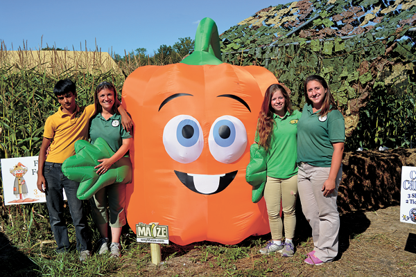Staff members stand alongside Spookley the Square Pumpkin, an anti-bullying mascot. Several activities and a children's maze have been dedicated to anti-bullying education at `The Maize.` From left are Kieran Garland, organizer Traci Garland, Elizabeth Robbins and Beth Sharry.