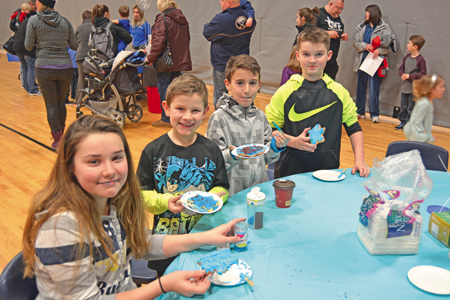 Cameron Dwyer, Cole and Shaun McCleary and Brody Dwyer, all of Wheatfield, pose for a photo while decorating treats.