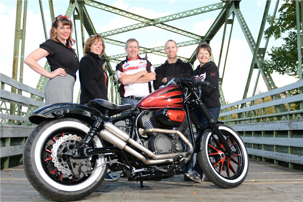 Bob Weaver Motorsports shows the winning bike from the 2014 Battle of the Bolts design contest. Pictured, from left, model Karlin Danahy, Sue Tsakos (office manager of Bob Weaver Motorsports), Bob Weaver of Grand Island (owner), Jim Royce, and Kyle Hall (title clerk of Bob Weaver Motorsports). (photo by K&D Action Sports and Aerial Imaging) Click for a larger image.