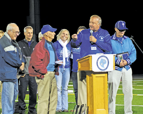 H. David Myers, the first athletic director of Grand Island Central School District, left, was honored by current AD Jon Roth at Friday Night Under the Lights.