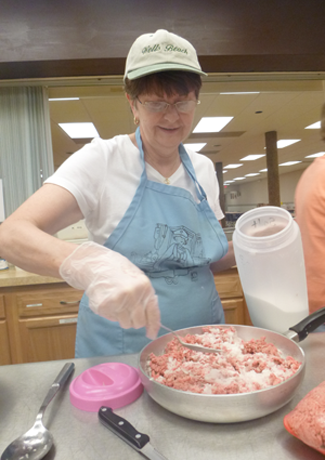 Donna McCrohan seasons ground beef at the kitchen at the Our Lady of Czestochowa parish hall in North Tonawanda.