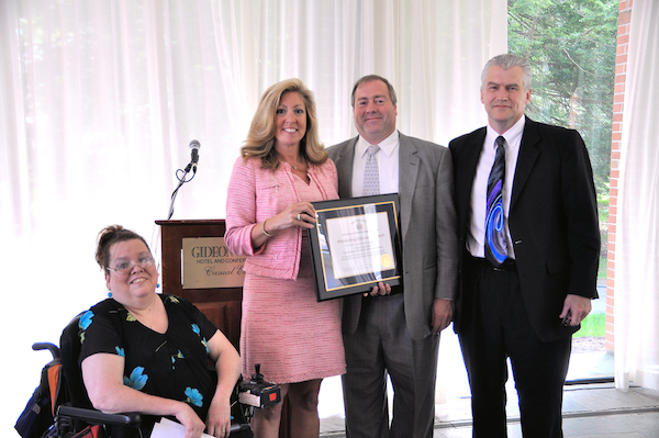 Wendy Orzel, chair of the DDPC consumer caucus, and Lisa Rosano, chair of the DDPC's children's issues committee, present the 2014 Forging Pathways Award to FRDAT project director David Whalen and Dr. Tim Ireland, dean of Niagara University's College of Arts and Sciences. 