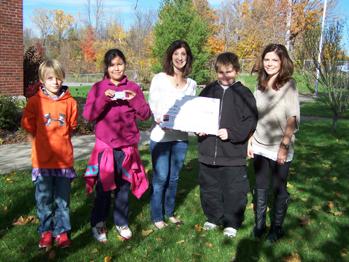 Tuscarora Indian School students Chase Chapman, Haley Navenma and Karson Swanson are joined by Guidance Counselor Kate Thurman to present a check for $535.00 to Maureen Rizzo of Niagara Hospice.