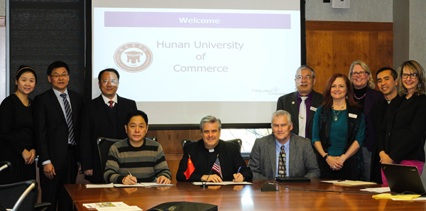 Representatives from Niagara University and the Hunan University of Commerce (China) celebrate the signing of an `agreement to cooperate` during a ceremony held in NU's Bisgrove Hall on Nov. 15.