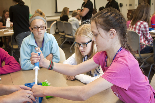 Student Molly Dineen takes a turn utilizing a vortexing apparatus during a Niagara University camp intended to introduce girls to the fields of science, technology, engineering and math.