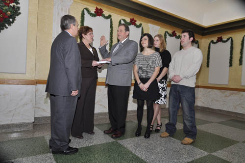 With his wife, Beth, holding the Bible, 138th District State Assemblyman John Ceretto was sworn into office by State Sen. George Maziarz last Saturday in a ceremony at the Como Restaurant. Joining him are his children: Theresa, Anne Marie and John II. (photo by Kevin and Dawn Cobello, K&D Action Photo)