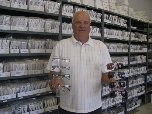 Mike Trombley, owner of Eye Deal Eyewear Inc. on Military Road, shows off a few of the eyeglass frames available at his warehouse business.