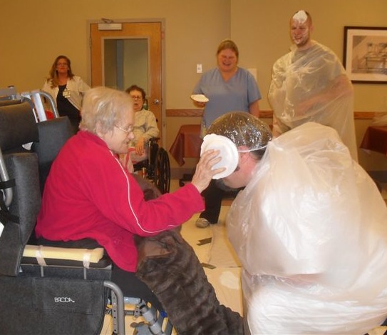 In the photo above, left, Nate Kennedy, RN, associate director of hospice and palliative care, gets what's coming to him from resident June Stanley. 